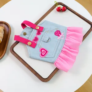 Detail of pink chiffon hem and denim pet dress with metal D-ring for leash attachment