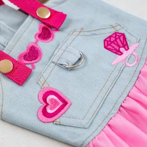 Detail of pink embroidered heart, denim fabric and D-ring on the pet dress for small dogs