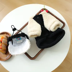 Detailed view of plush pet fleece vest and hat set on a wooden tray for small dogs