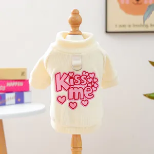 Detail of cream pet sweater with pink heart embroidery and D-ring for leash attachment