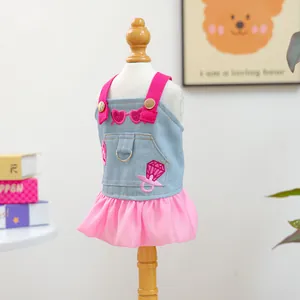 Detail of pink denim pet dress with heart embroidery and D-ring for leash attachment