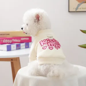 Detail of pet knit sweater with Kiss Me embroidery and metal D-ring for leash attachment