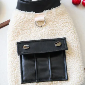 Close-up of lamb wool pet vest featuring black leather pockets and metal D-ring attachment