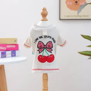 Detail of cream rib-knit pet sweater with cherry embroidery and D-ring on hanger