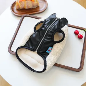 Close-up of pet winter vest featuring black PU leather and soft white fleece lining