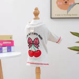 Detail of pet shirt with cherry embroidery, bow accent, and built-in leash D-ring