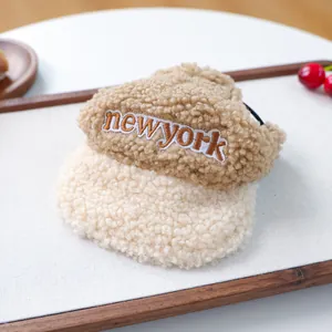 Détail d'un chapeau doux pour animaux en laine d'agneau avec broderie New York beige