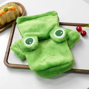 Detail of green plush frog pet hoodie featuring embroidered eyes and metal D-ring attachment