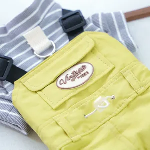 Detail of pet overalls with adjustable buckles, metal D-ring and vintage chest patch