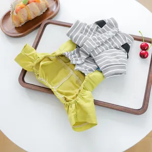 Detail of cute yellow pet overalls with gray striped cotton and snap buttons