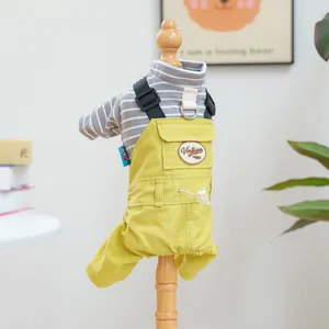 Detail of yellow pet overalls with D-ring leash attachment and vintage embroidery