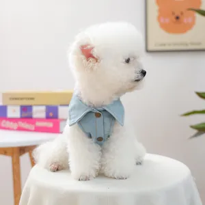 Detail of light blue denim dog vest featuring a lapel collar and gold vintage buttons