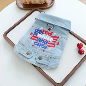 Macro detail of dog denim vest featuring star embroidery and metal D-ring for leash