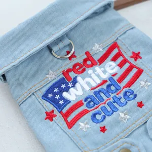 Detail of light blue pet denim vest with 'red white and cute' embroidery and metal D-ring