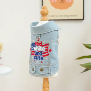 Close-up of star embroidery and D-ring on light blue denim pet vest with flag detail