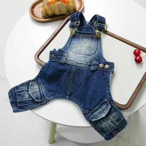 Denim dog overalls for small pets with adjustable metal buckles on a white background