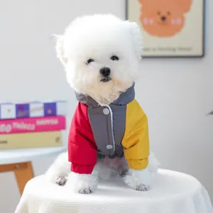 Fleece-lined winter dog jacket with grey hood, three-color patchwork, and metal buttons