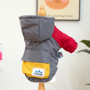 Detail of color-block pet winter coat with explore label and metal D-ring for leash