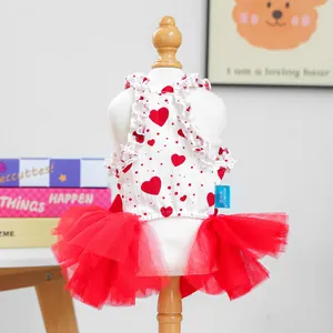 Detail showing red heart patterns and multilayered mesh tutu on a white pet dress
