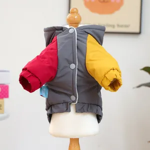 Detail of color-blocked pet jacket with hood, snap buttons and soft windproof fabric