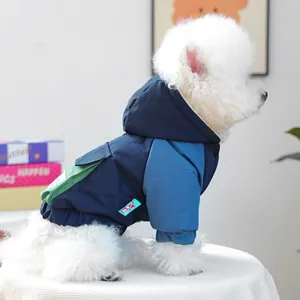 Detail of tricolor hooded winter dog jacket featuring windproof fabric and pocket