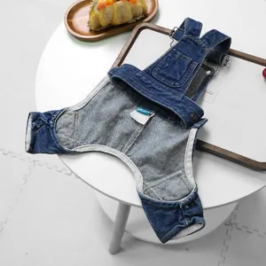 Detail view of denim dog overalls with adjustable metal buckles and back pocket
