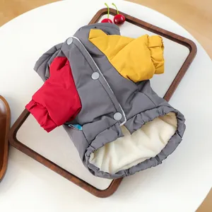 Detail of three-color pet winter coat with thick cream fleece lining and snap closures