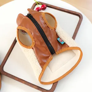 Detail of pet vest showing brown leather texture, fleece lining, and back zipper closure