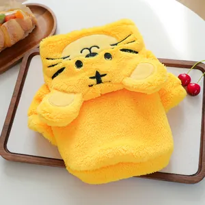 Bright yellow plush pet apparel with a cartoon tiger face on a wooden tray