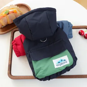 Macro view of pet hooded vests showing harness D-rings, pockets, and three color options