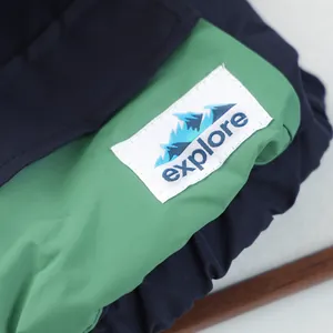 Detail of waterproof dog jacket with green contrast fabric and explore patch