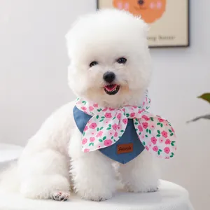Floral denim pet bandana with pink bow for dogs and cats on a white poodle