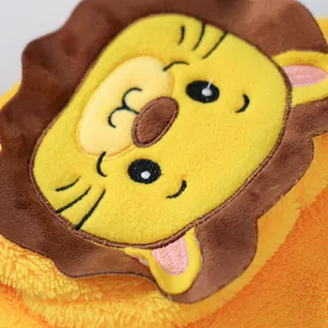 Close-up of plush lion dog costume featuring detailed embroidery and soft orange faux fur