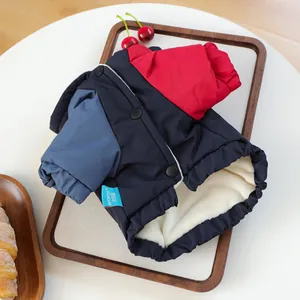 Detail of color-block pet coat with warm fleece lining and snap buttons in a tray