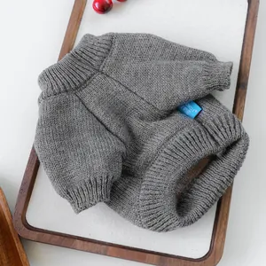 Close-up of grey knit pet sweater featuring ribbed collar and Dog Circle brand label