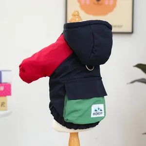 Detail of dog hooded jacket showing patchwork colors, D-ring, and Explore pocket patch