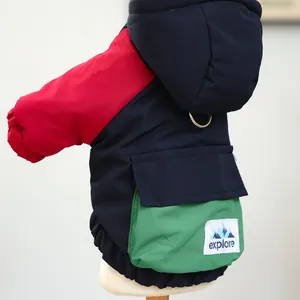 Detail of multi-color pet winter coat with functional pocket and metal leash D-ring