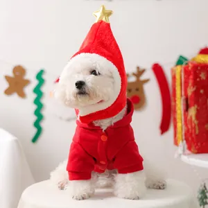 Detail of red fleece pet Christmas outfit with a gold star hat worn by a white dog