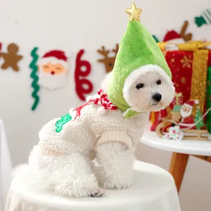 Detail of soft fleece pet Christmas sweater and green tree hat with golden star