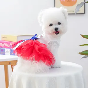 Detail of red tiered mesh skirt and blue bow on white pet princess dress for small dogs