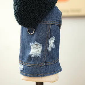 Close-up of distressed denim pet vest with black sherpa fleece hood and metal D-ring attachment