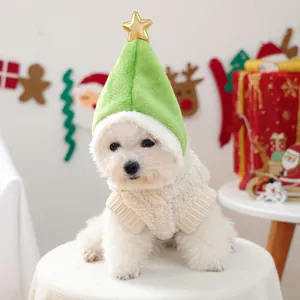 Close-up of green Christmas tree hat with gold star and fleece pet vest on small dog