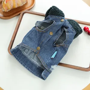Detail of dog denim vest with green sherpa lining and brass button fasteners
