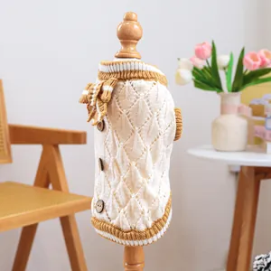 Detail of pet knit sweater with hollow diamond patterns and yellow bow decoration