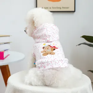 Detail of pink floral pet hoodie featuring a cute bear embroidery and soft fabric texture