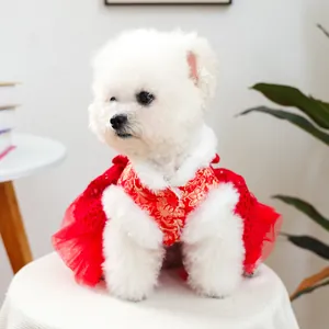 Red festive dog dress with traditional floral embroidery and white faux fur trim