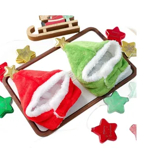 Festive red and green plush pet Christmas hats with gold stars on a wooden tray