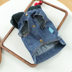 Detail view of denim pet vest with green faux shearling collar and bronze snap buttons