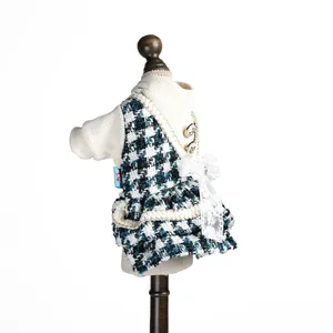 Détail d'une robe pour chien avec haut en tricot, jupe pied-de-poule et nœud en dentelle