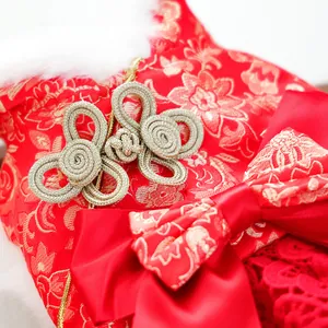 Detail of red floral brocade dog dress with gold knot buttons and faux fur collar